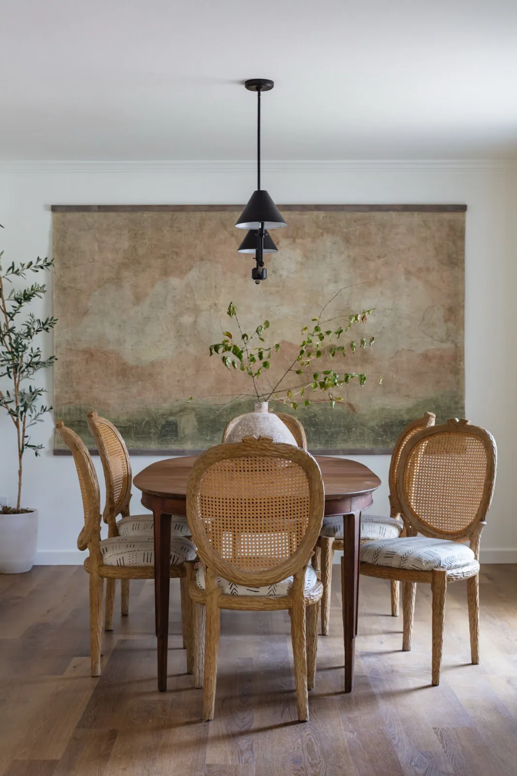 Dining room with a hand-painted landscape mural