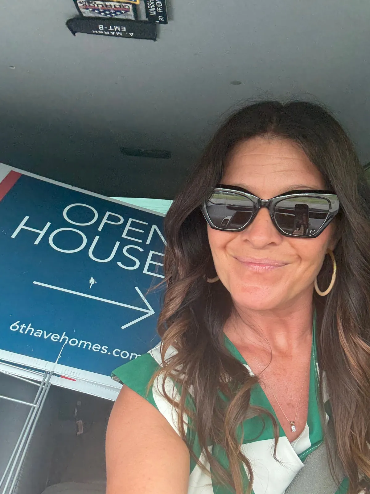 Jenny Marsh in her car with a 6th Ave Homes open house sign