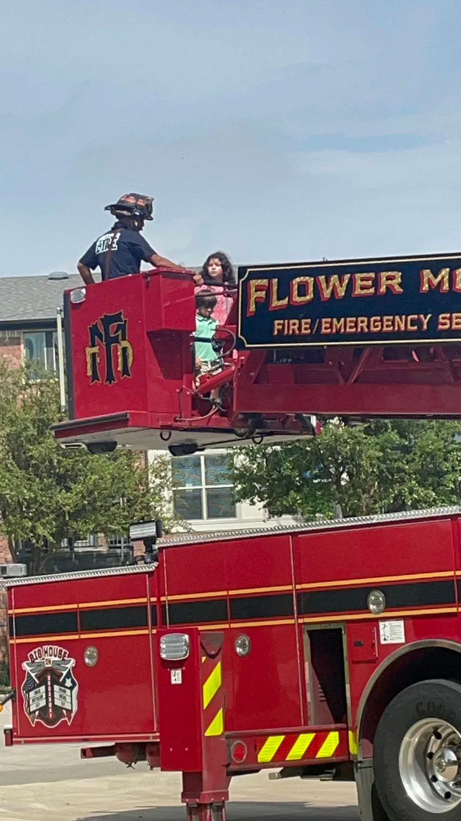 Jenny's kids in the bucket of a Flower Mound fire truck
