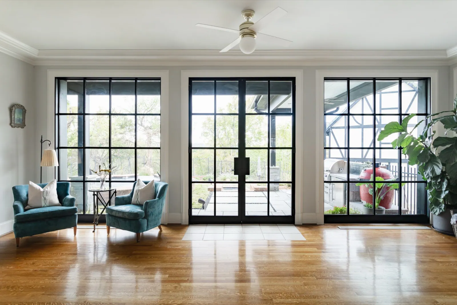 Steel and glass doors opening to a patio