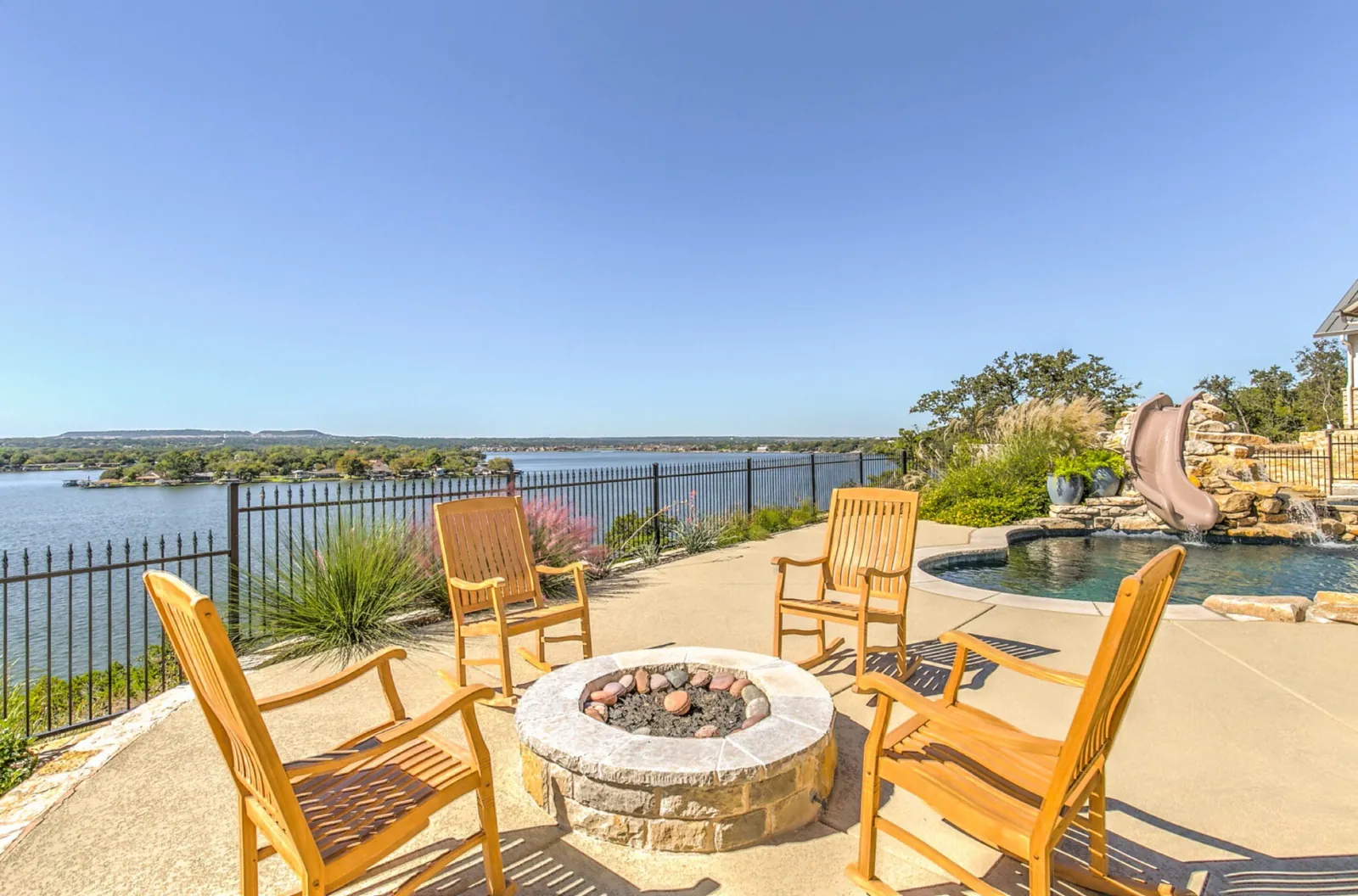 Firepit and rocking chairs above a lake